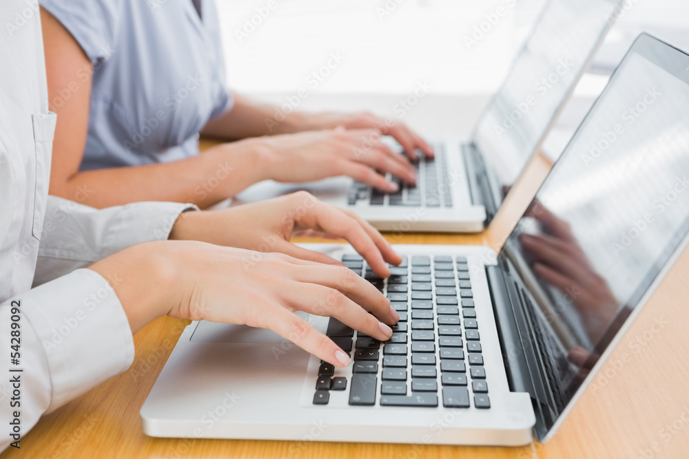 Businesswomens hands typing Businesswomens hands typing