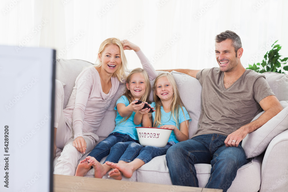 Twins and parents watching television