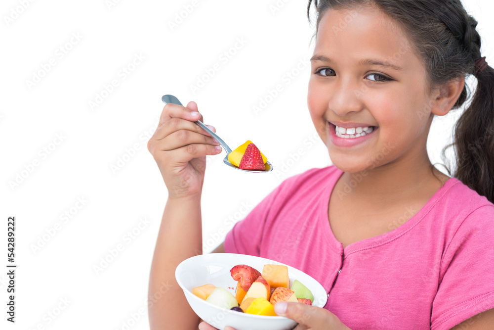 Smiling little girl eating fruit salad Smiling little girl eating fruit salad