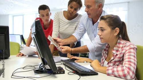 Teacher with students in computing class