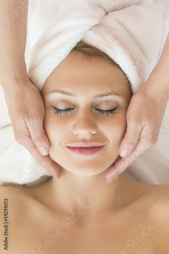 Beautiful Woman Receiving Facial Massage In Spa