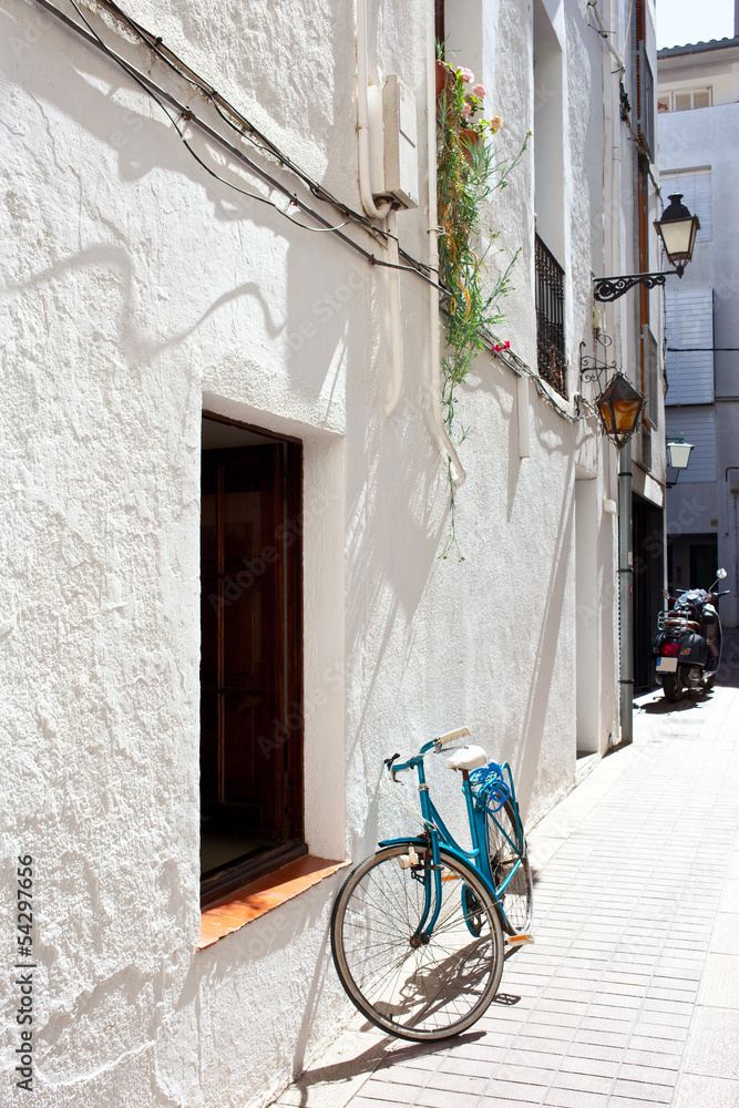 blue bicycle at a white wall