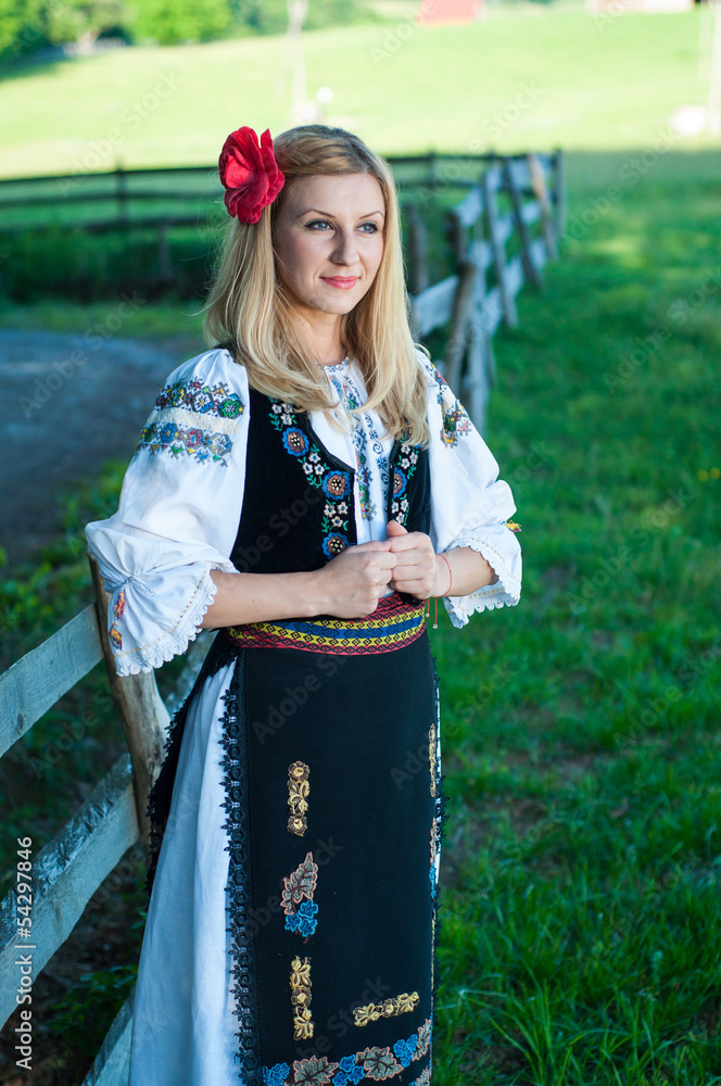 beautiful woman with red flower in her hair posing in Romanian t beautiful woman with red flower in her hair posing in Romanian t