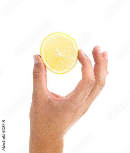 Hand holds lemon slice.