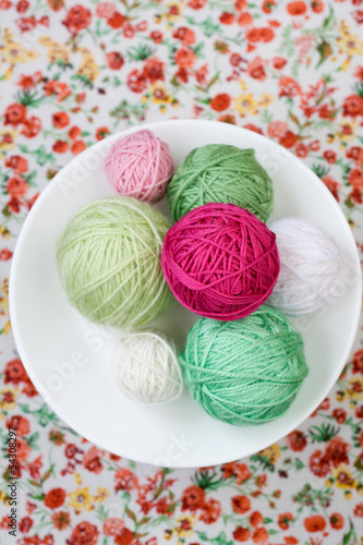 A lot of bright balls of knitting on the background