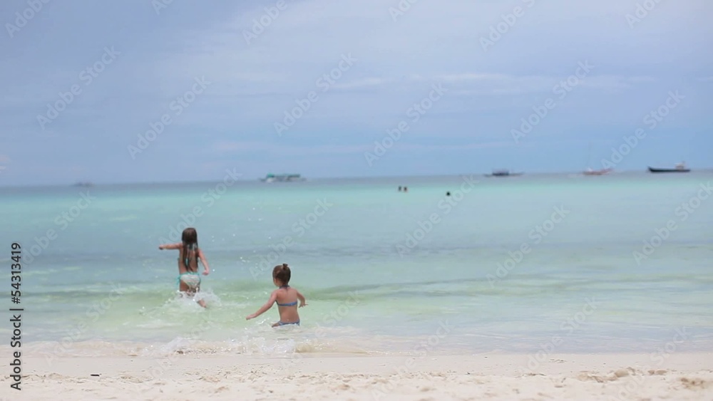 two little sisters at tropical beach in Philippines two little sisters at tropical beach in Philippines