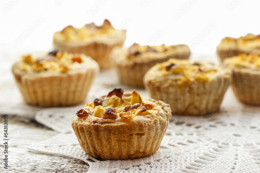 Homemade tart with dried fruits and fresh apples on white wooden Homemade tart with dried fruits and fresh apples on white wooden