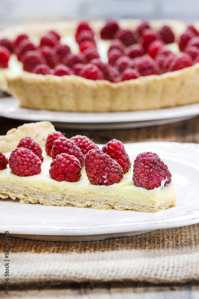 Raspberry tart on wooden table Raspberry tart on wooden table