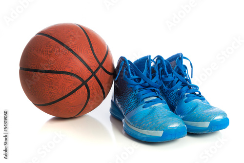 Basketball with blue basketball shoes on white