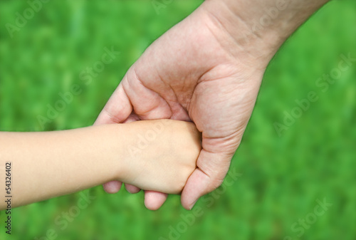 Child holds the hand of the father © svetamart