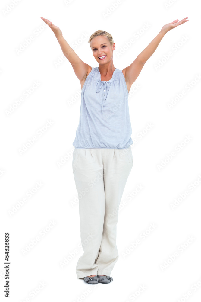 Smiling woman standing with hands up in air Smiling woman standing with hands up in air