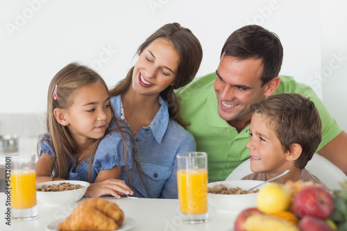 Parents having breakfast with their children