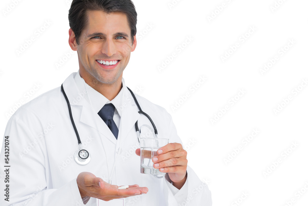 Smiling doctor holding tablets and water Smiling doctor holding tablets and water