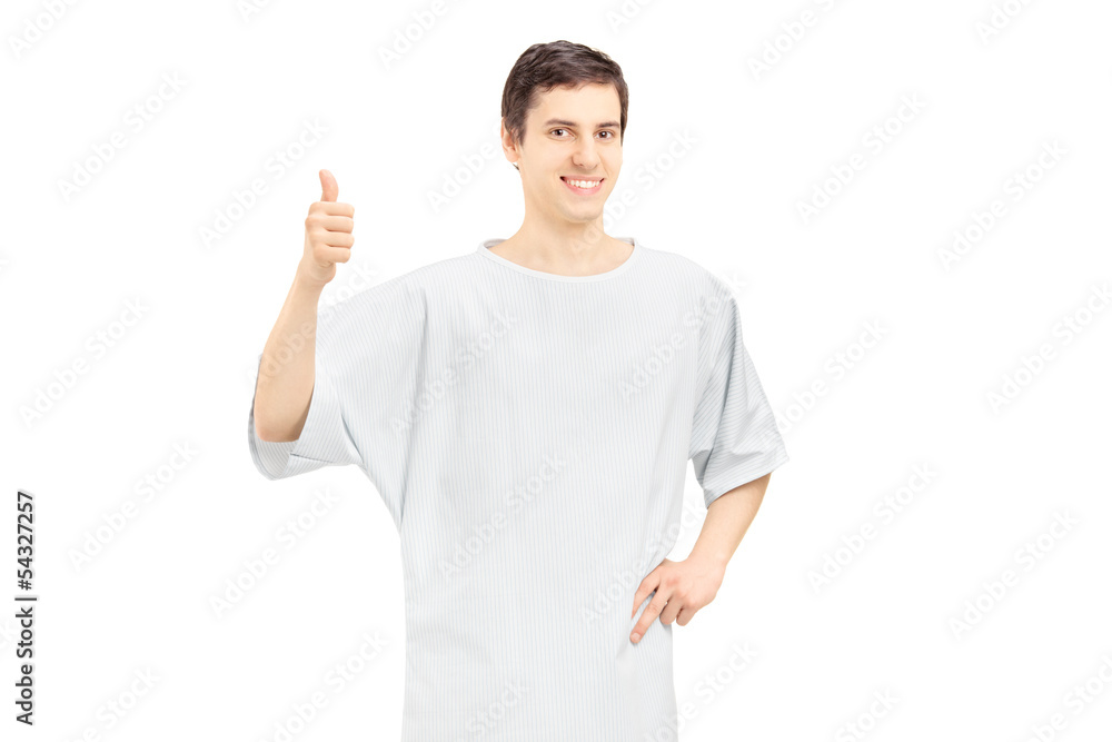 Smiling male patient wearing hospital gown and giving thumb up Smiling male patient wearing hospital gown and giving thumb up