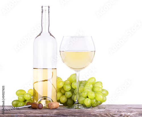 grapes on a tablel with corkscrew and wine