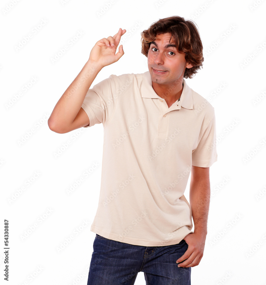 Attractive man crossing fingers while standing Attractive man crossing fingers while standing