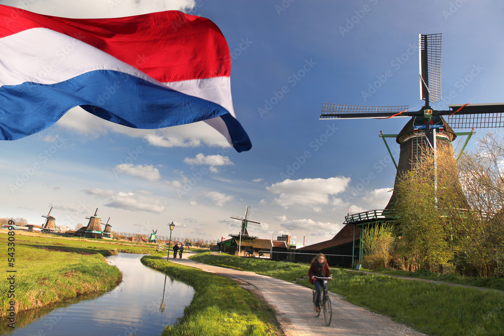 Windmills with flag of Holland in Zaanse Schans - obrazy, fototapety, plakaty 
