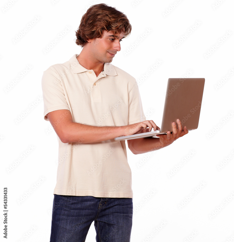 Charming man working on laptop while standing Charming man working on laptop while standing