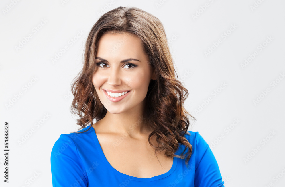 Happy smiling young woman, over grey