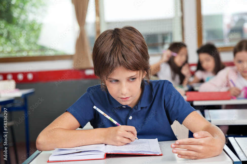 Schoolboy Cheating At Desk During Examination Schoolboy Cheating At Desk During Examination