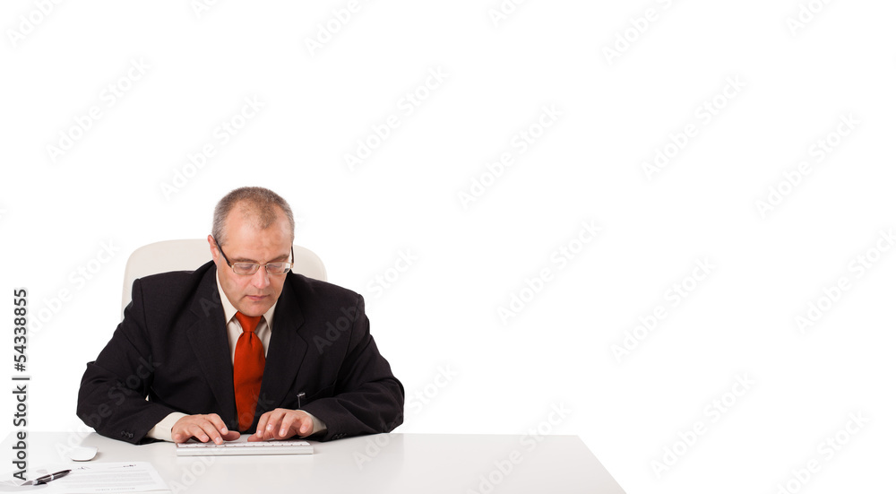 businessman sitting at desk and typing on keyboard with copy sca businessman sitting at desk and typing on keyboard with copy sca