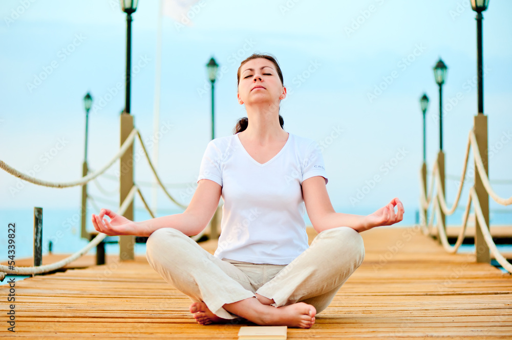 woman dressed in white doing yoga