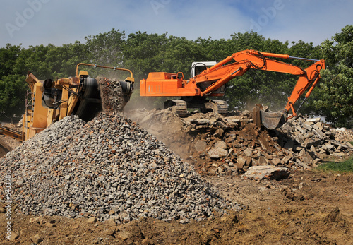 Stone crusher and crane in working photo