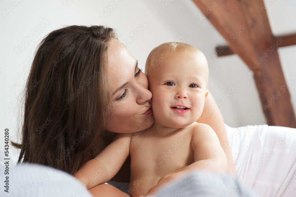Loving mother kissing child Loving mother kissing child