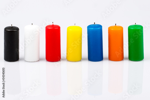 seven colored candles on a white background