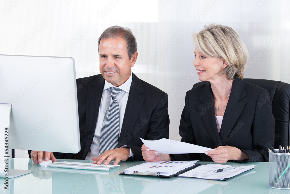 Mature Businessman And Businesswoman At Work Mature Businessman And Businesswoman At Work
