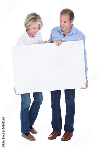 Portrait Of Mature Couple Holding Placard