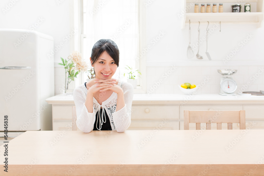 young asian woman relaxing in the kitchen young asian woman relaxing in the kitchen