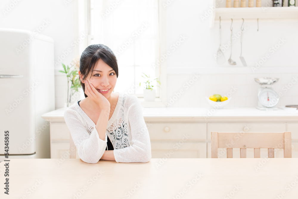 young asian woman relaxing in the kitchen young asian woman relaxing in the kitchen