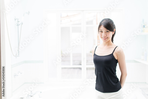 young asian woman relaxing in the bathroom