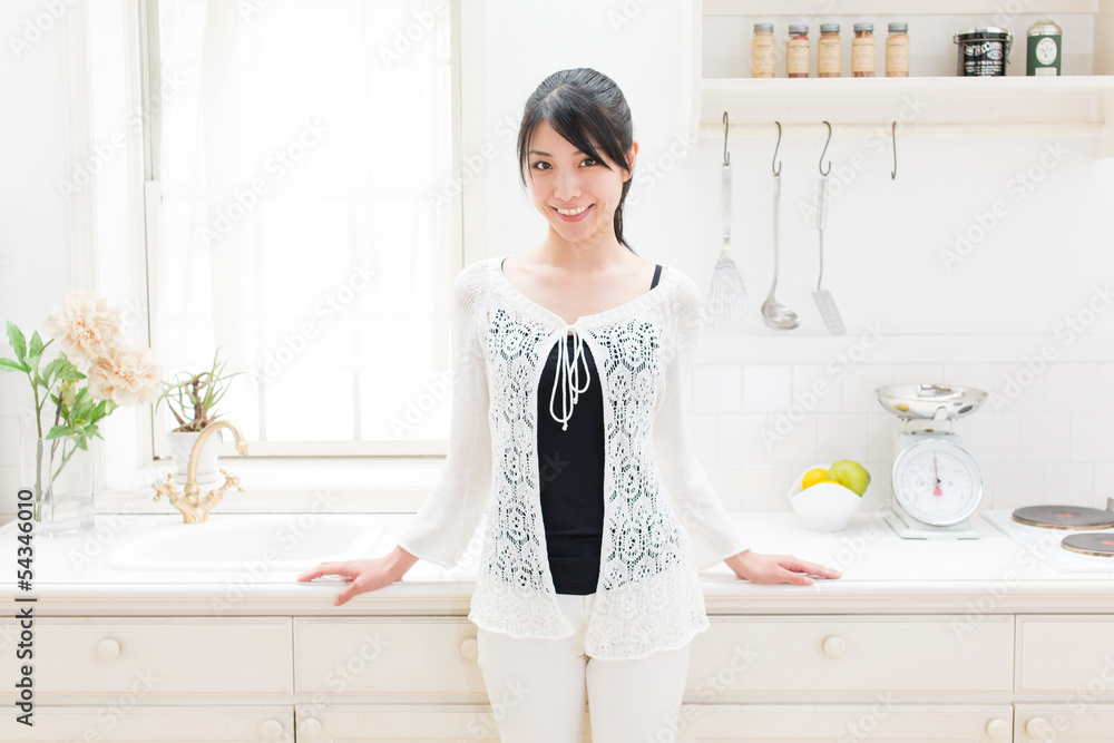 young asian woman relaxing in the kitchen young asian woman relaxing in the kitchen