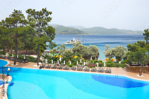 Swimming pool and yacht at the pier on Mediterranean turkish res
