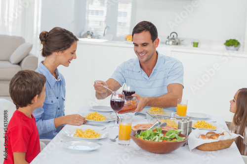 Man serving wife during the dinner