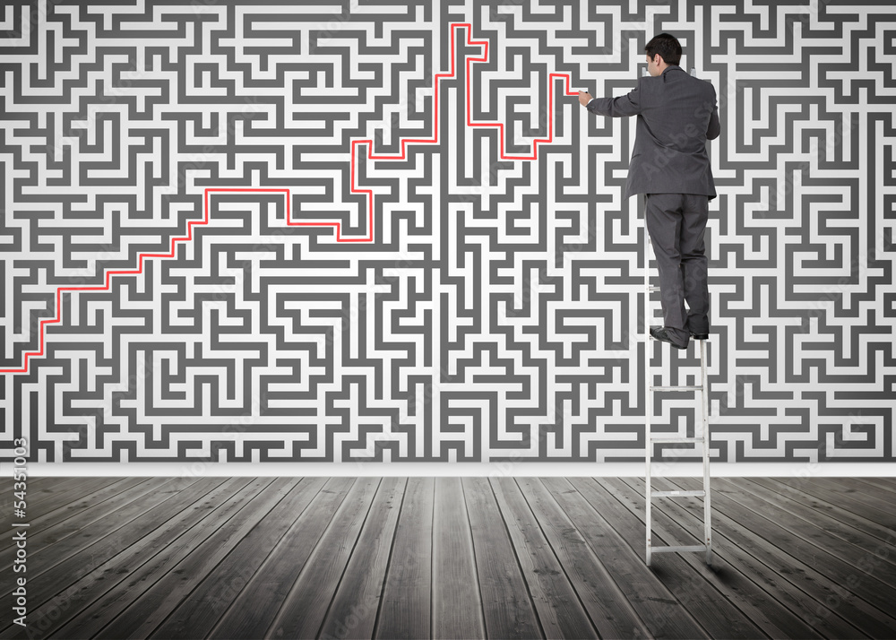 Businessman standing on a ladder solving maze puzzle Businessman standing on a ladder solving maze puzzle