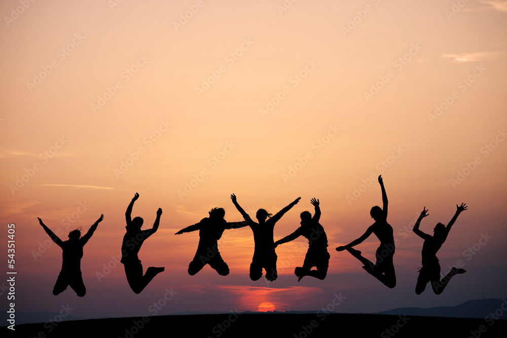 silhouette of friends jumping in sunset silhouette of friends jumping in sunset