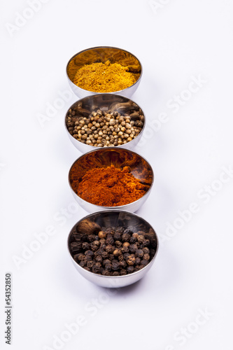 Curry, pepper, paprika and coriander - white background.
