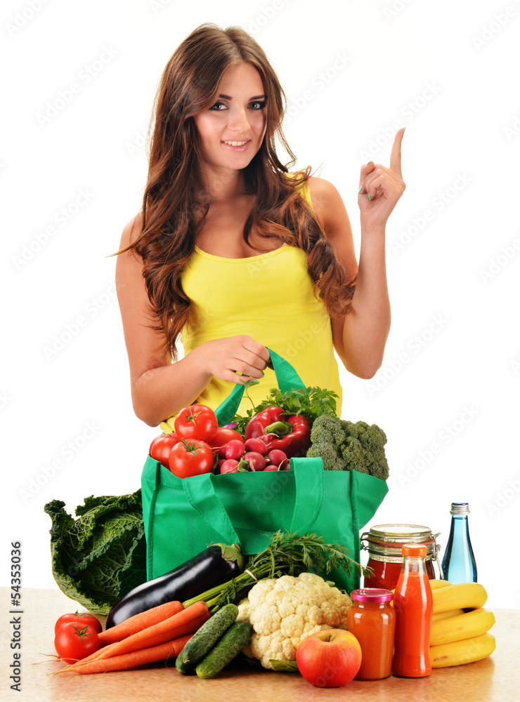 Young woman with variety of grocery products in shopping bag Young woman with variety of grocery products in shopping bag