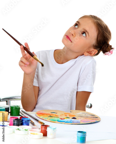 Cute little girl painting a...
