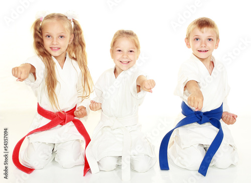 Children to sit in a ceremonial kimono karate pose and hit