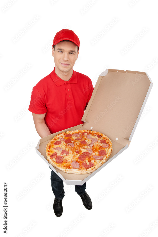 Delivering pizza. Top view of cheerful young deliveryman holding Delivering pizza. Top view of cheerful young deliveryman holding