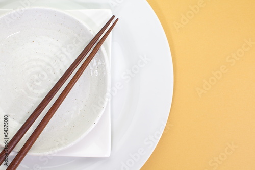 Empty white plate with chopsticks