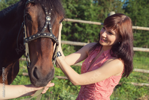 Young caucasian woman bonding with her horse at summer © Nickola_Che