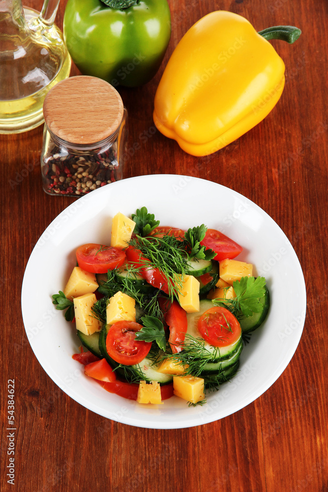Light salad in plate on wooden table Light salad in plate on wooden table