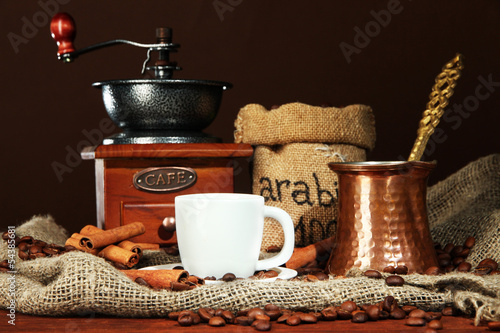 Metal turk and coffee cup on dark background