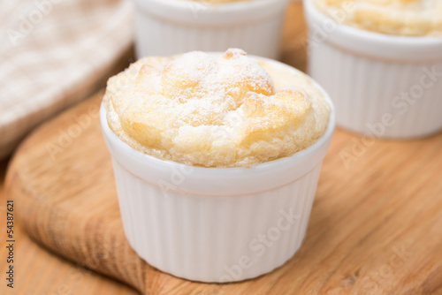 peach souffle in the portioned form on a wooden board, close-up