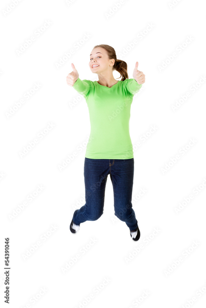 Young happy caucasian woman jumping in the air with thumbs up Young happy caucasian woman jumping in the air with thumbs up
